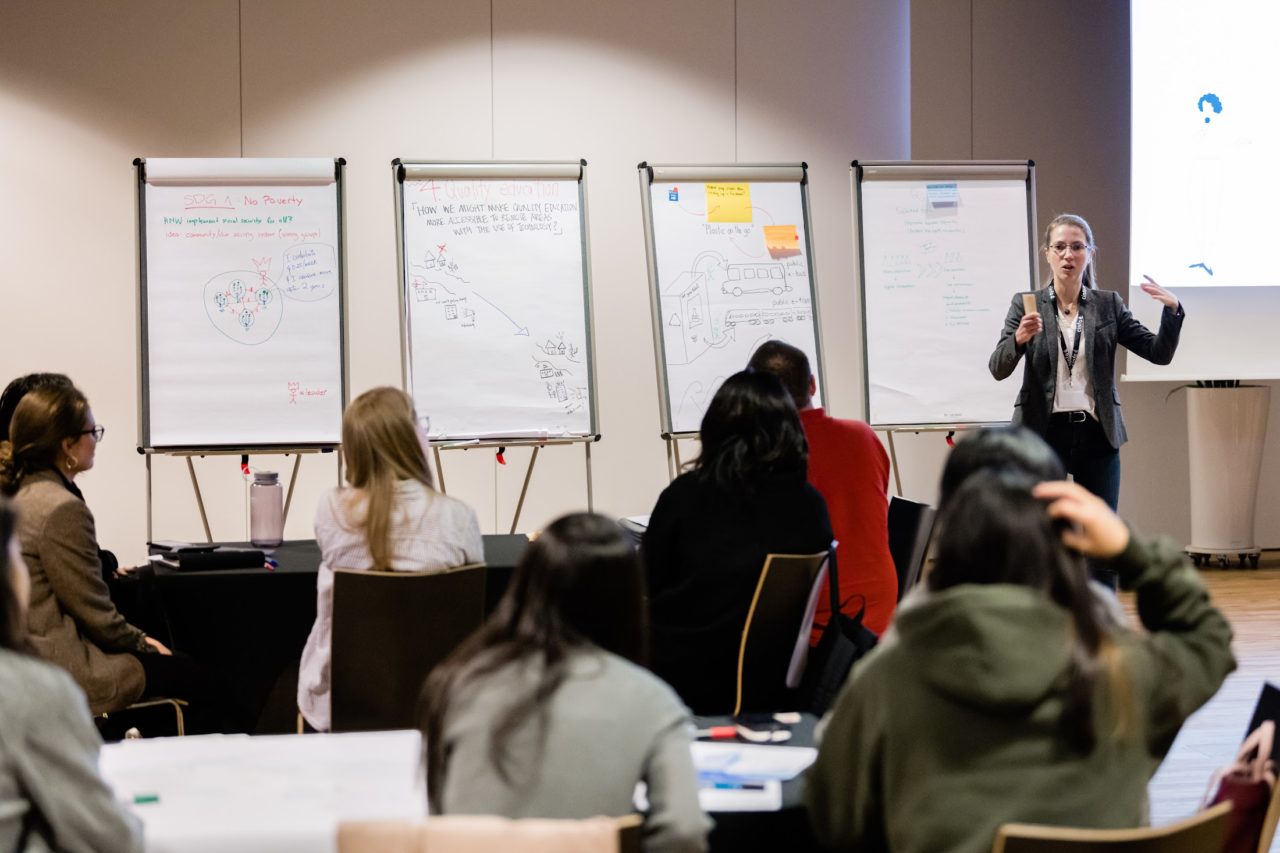 Marie Kuter, UX speaker speaking in front of an audience